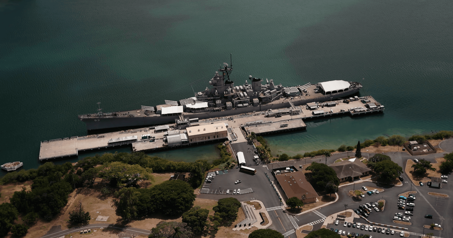Aerial view of a battleship docked at Pearl Harbor on Oahu