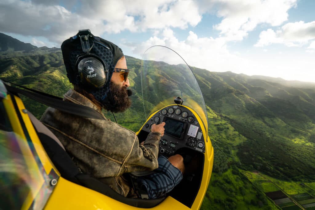 Open-cockpit gyroplane over Oahu's North Shore coastline at 1,000 feet